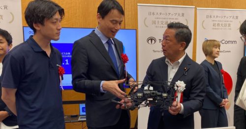 授賞式でドローン実機を前に説明する徳重氏(中央)